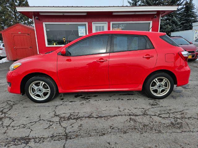 2009 Radiant Red Toyota Matrix Base 5-Speed MT (2T1KU40E09C) with an 1.8L L4 DOHC 16V engine, 5-Speed Manual transmission, located at 601 E. Idaho St., Kalispell, MT, 59901, 48.203983, -114.308662 - Photo #1