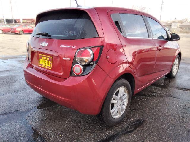 2013 Chevrolet Sonic LT Auto 5-Door (1G1JC6SB3D4) with an 1.4L L4 DOHC 24V TURBO engine, 6-Speed Automatic transmission, located at 4047 Montana Ave., Billings, MT, 59101, 45.770847, -108.529800 - Photo #4