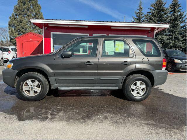 2007 Tungsten Grey Metallic Ford Escape XLS 4WD (1FMCU92Z87K) with an 2.3L L4 DOHC 16V engine, 4-Speed Automatic transmission, located at 601 E. Idaho St., Kalispell, MT, 59901, 48.203983, -114.308662 - Photo #1